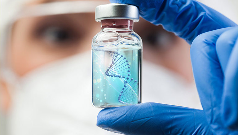 Scientist looking at molecule in vial